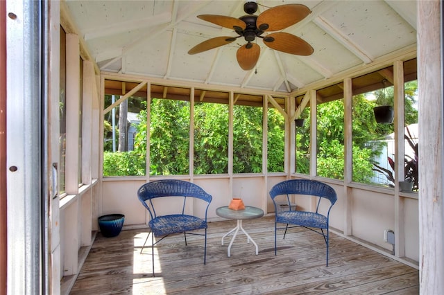 sunroom featuring vaulted ceiling and a ceiling fan