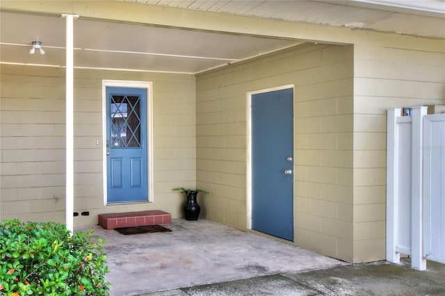 doorway to property with a patio area and concrete block siding