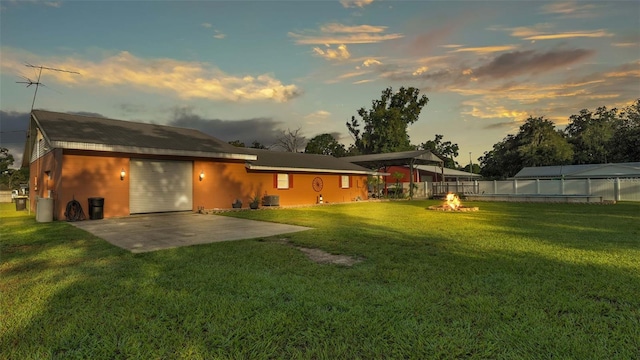 4390 Sunnyside Dr, Lakeland, FL 33810 - back of property with a yard, a patio, fence, an attached garage, and concrete driveway