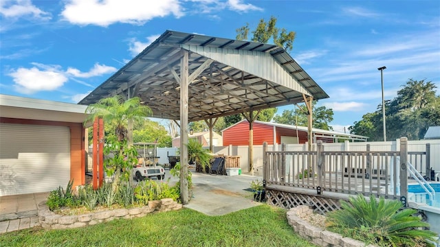 view of yard with a wooden deck and a carport