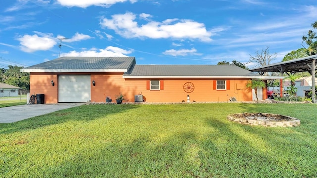 4390 Sunnyside Dr, Lakeland, FL 33810 - view of front facade featuring central AC, metal roof, a front yard, a garage, and driveway
