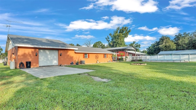 4390 Sunnyside Dr, Lakeland, FL 33810 - back of house with a patio, driveway, a garage, fence, and a lawn