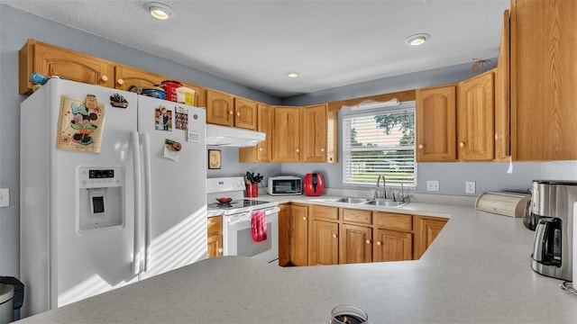 kitchen featuring white appliances, kitchen peninsula, and sink