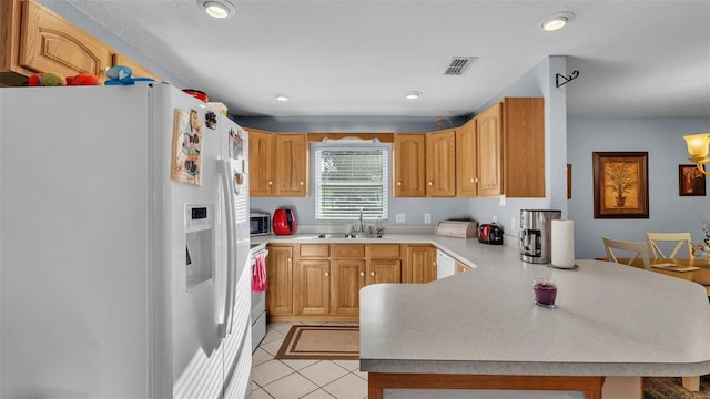 4390 Sunnyside Dr, Lakeland, FL 33810 - kitchen featuring white appliances, a peninsula, visible vents, light countertops, and a sink