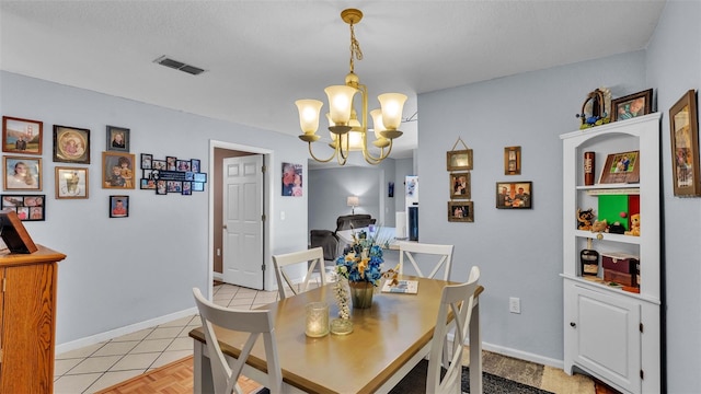 tiled dining room with a chandelier