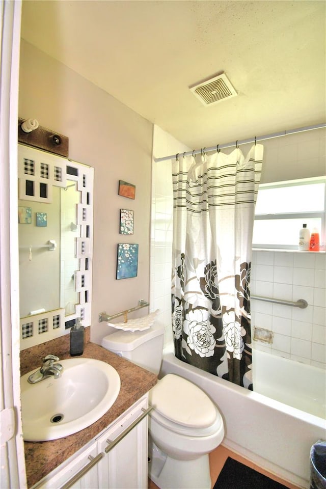 full bathroom featuring shower / bath combo, vanity, and toilet