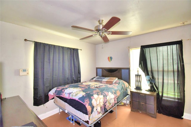 bedroom with ceiling fan and light carpet