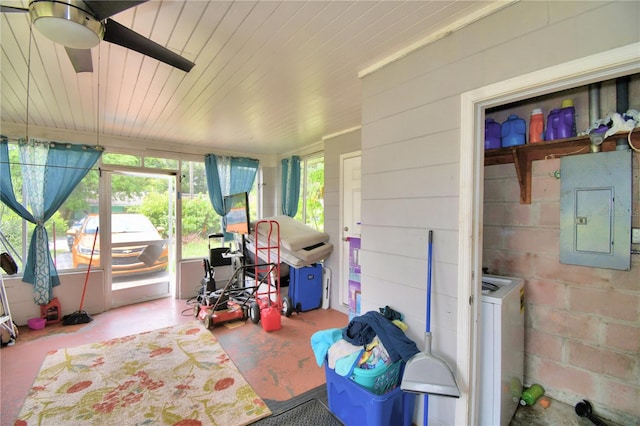 sunroom featuring washer / dryer, electric panel, and ceiling fan