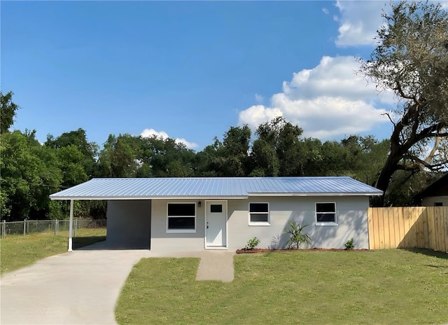 ranch-style home featuring a front yard and a carport