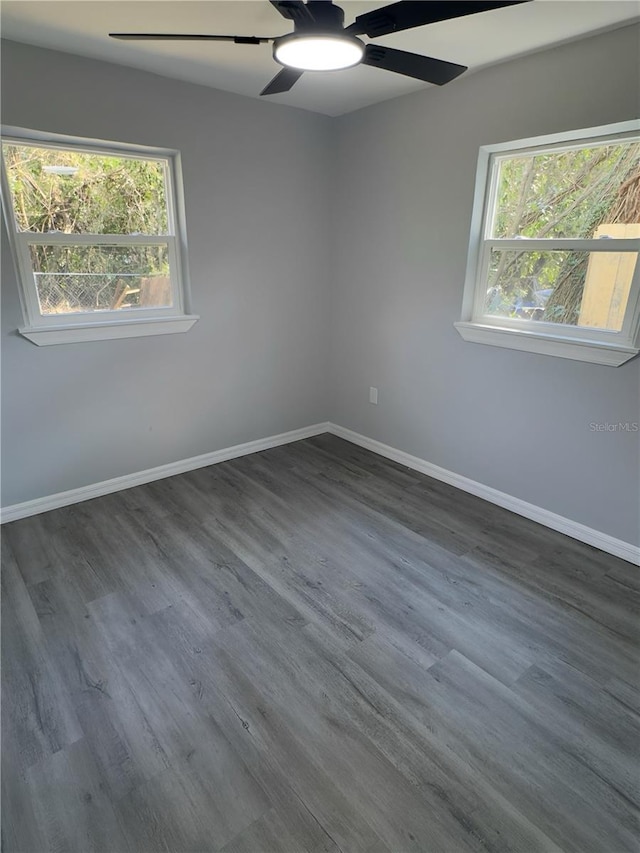 spare room featuring dark wood-type flooring and ceiling fan