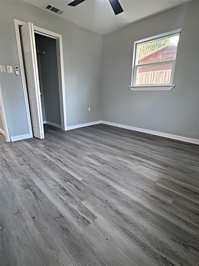 spare room with hardwood / wood-style flooring and ceiling fan