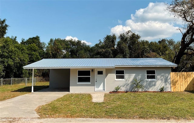 ranch-style home with a front lawn and a carport