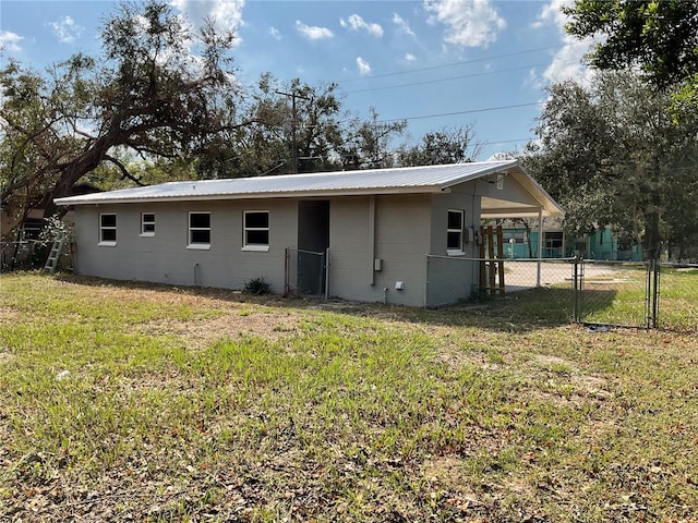 rear view of house with a lawn