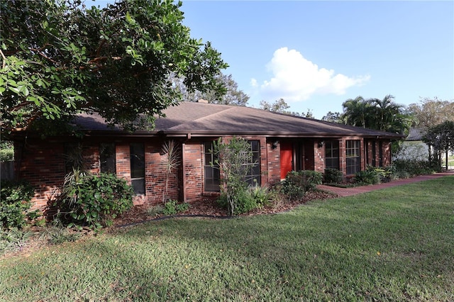 ranch-style house with a front lawn