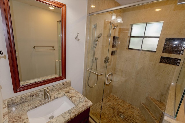 bathroom featuring vanity and a shower with shower door