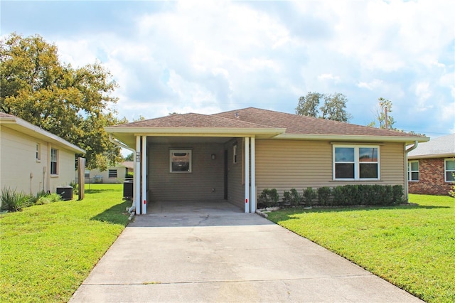 view of front facade with a front lawn and a carport