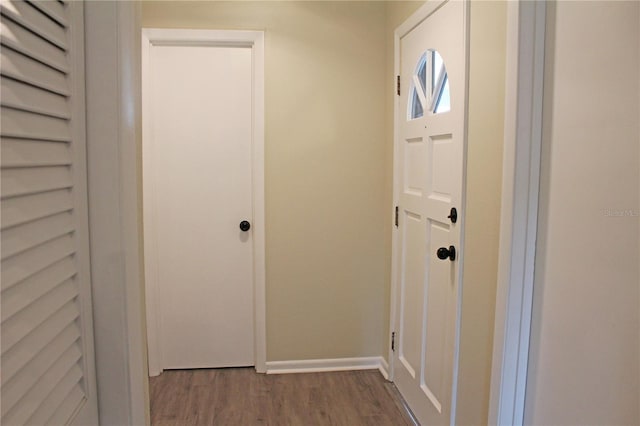 interior space with baseboards and wood finished floors