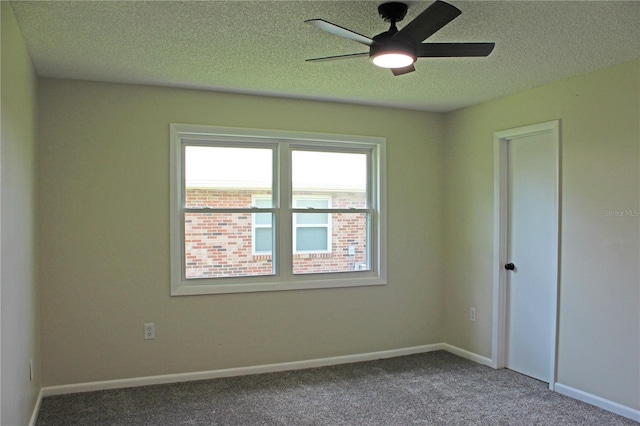 spare room with carpet flooring, a textured ceiling, and ceiling fan