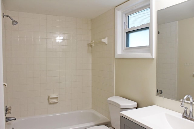 full bathroom featuring vanity, tiled shower / bath combo, and toilet