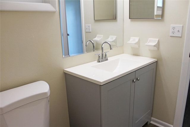 bathroom with toilet and vanity