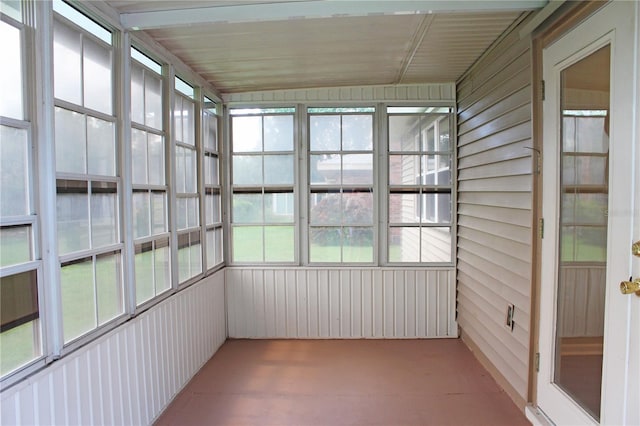 unfurnished sunroom featuring lofted ceiling