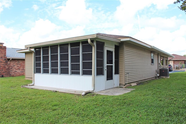 view of home's exterior with a yard and central AC