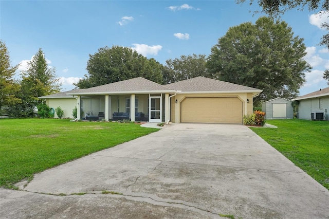 ranch-style home with a front yard, a garage, a storage unit, and covered porch