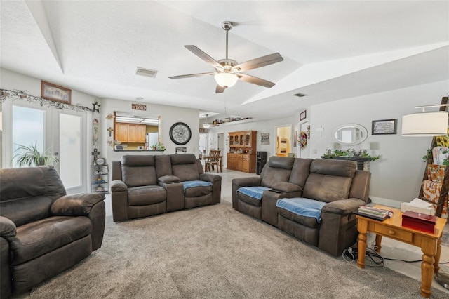 living room with ceiling fan and carpet