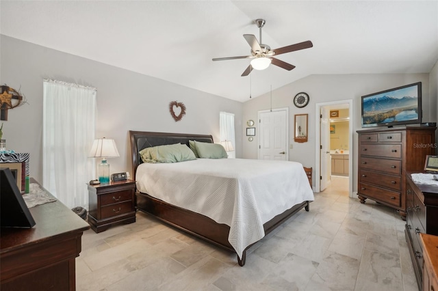 bedroom with ceiling fan, ensuite bathroom, and vaulted ceiling