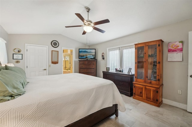 bedroom featuring connected bathroom, ceiling fan, and vaulted ceiling