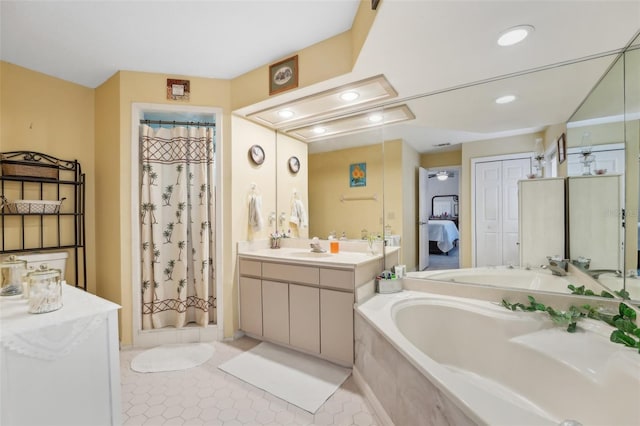 bathroom featuring plus walk in shower, vanity, and tile patterned floors