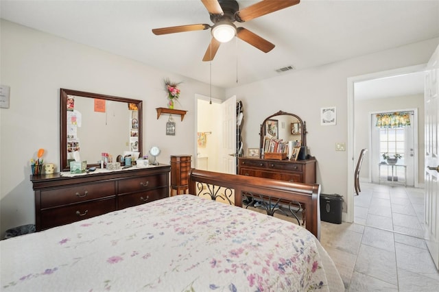 bedroom with ceiling fan and light tile patterned floors