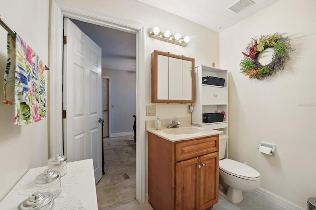 bathroom with tile patterned floors, vanity, and toilet