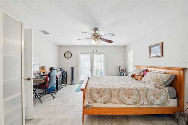 bedroom with french doors, a textured ceiling, and ceiling fan