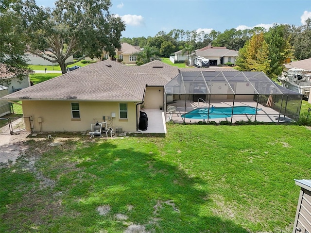 back of property featuring a lanai, a patio area, and a lawn