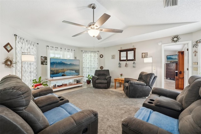 carpeted living room with ceiling fan, lofted ceiling, and a textured ceiling