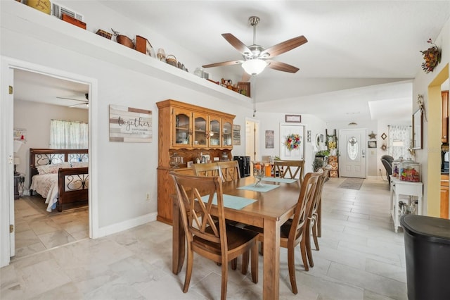 dining space with ceiling fan and lofted ceiling