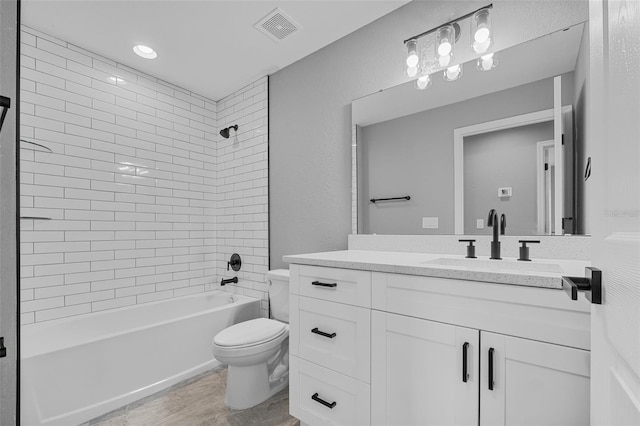 full bathroom featuring vanity, toilet, and tiled shower / bath