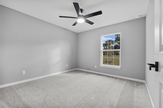 spare room featuring ceiling fan and carpet