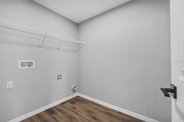 washroom with dark hardwood / wood-style flooring, washer hookup, and hookup for an electric dryer