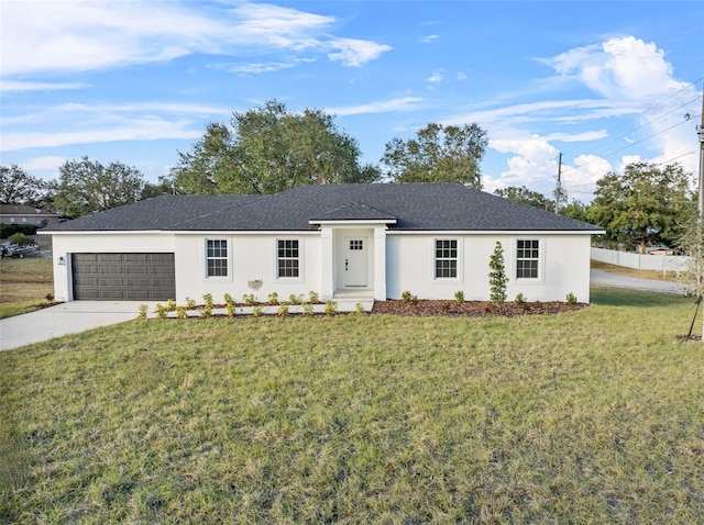 ranch-style home with a garage and a front lawn