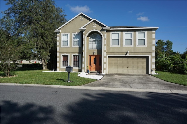 view of front of home featuring a front yard and a garage