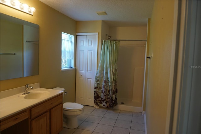 bathroom with vanity, toilet, a textured ceiling, tile patterned flooring, and a shower with shower curtain