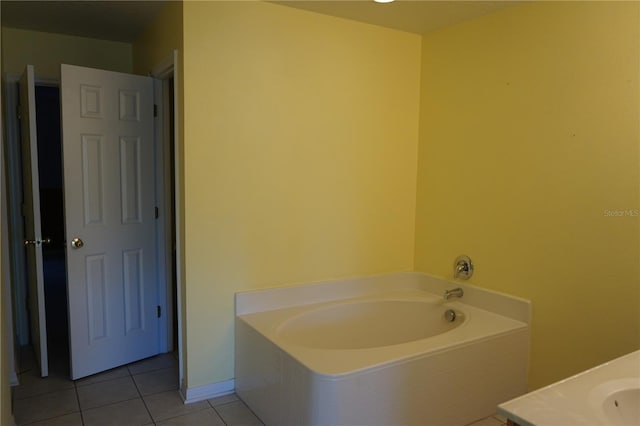 bathroom with a bathtub and tile patterned floors