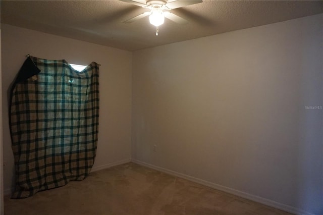 unfurnished room featuring carpet floors, a textured ceiling, and ceiling fan