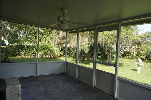 unfurnished sunroom featuring ceiling fan and a healthy amount of sunlight