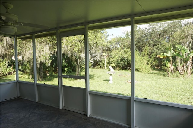 unfurnished sunroom with ceiling fan and plenty of natural light