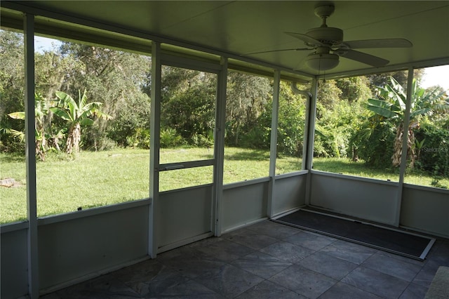 unfurnished sunroom featuring ceiling fan