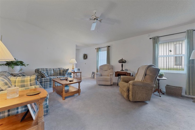 living room featuring carpet floors, a textured ceiling, and ceiling fan