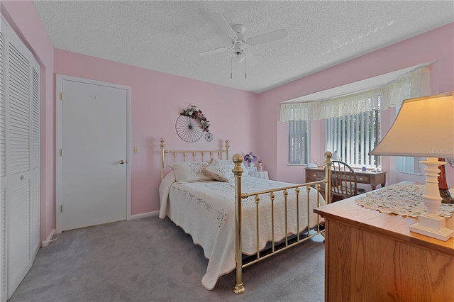 bedroom featuring ceiling fan, a textured ceiling, a closet, and carpet flooring